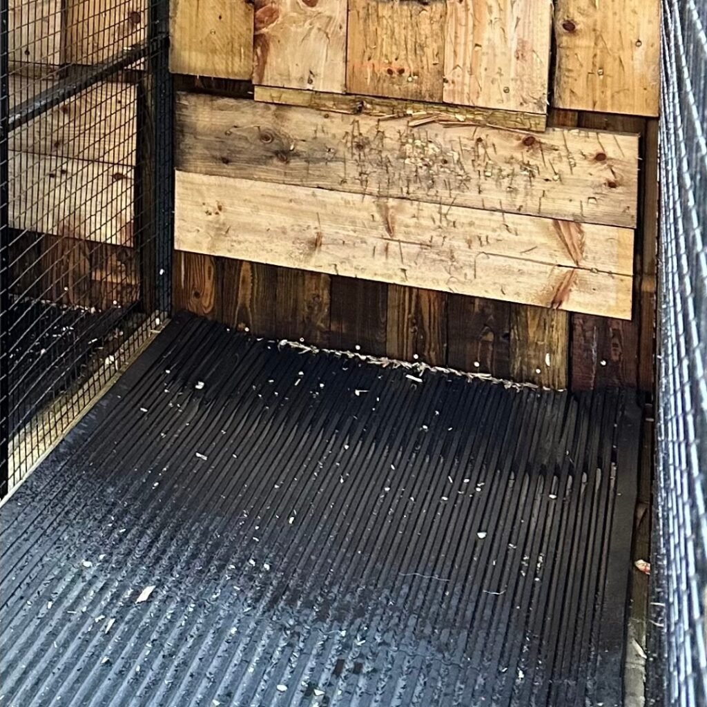 Rubber mat under target on axe throwing lane