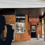 Outside of axe throwing shed structure with sign for axe throwing and other fun activities at Mazewood entertainment centre