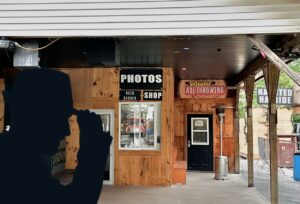 Outside of axe throwing shed structure with sign for axe throwing and other fun activities at Mazewood entertainment centre