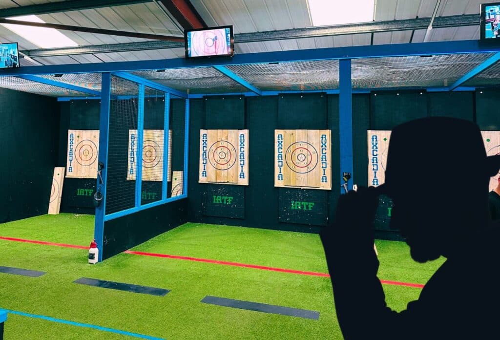 View of six axe throwing targets inside a gym-type warehouse space