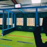 View of six axe throwing targets inside a gym-type warehouse space