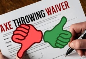 Someone signing an axe throwing waiver with a large red thumbs down and green thumbs up in front