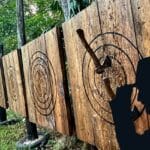 outdoor axe throwing boards with a silhouette of the Axe Inspector in front